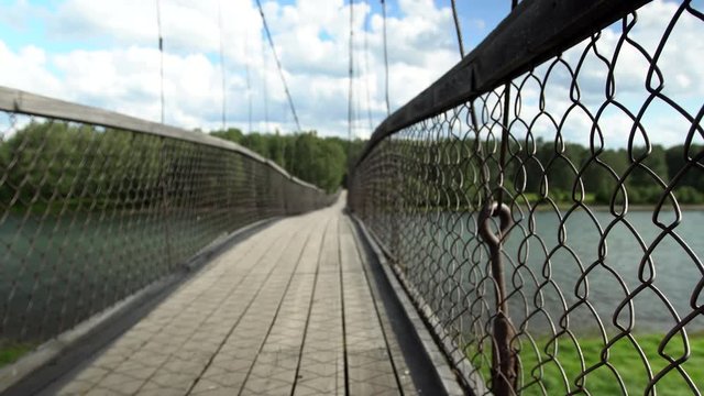 Suspension bridge over the mountain river