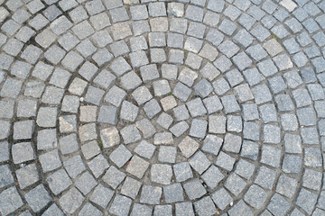Texture of old Cobbled Pavement close-up. Abstract Granite Stone Background.