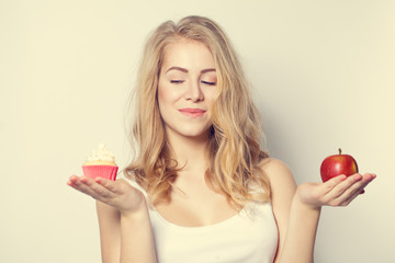 Smiling Beautiful Woman with crafty look. Difficult choice betwe