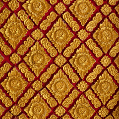 The color golden stucco on red and Thai art wall pattern