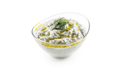 Tzatziki sauce in a glass bowl isolated on white background