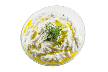 Tzatziki sauce in a glass bowl isolated on white background