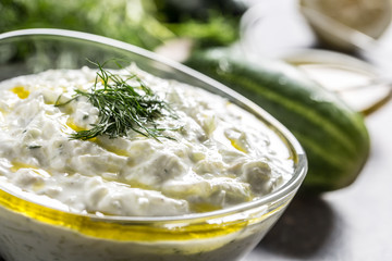 Tzatziki sause in a glass bowl dill cucumber olive oil lemon and garlic