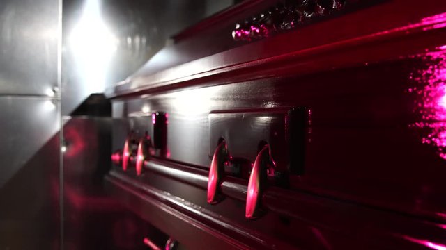 Coffin in front of cremation oven