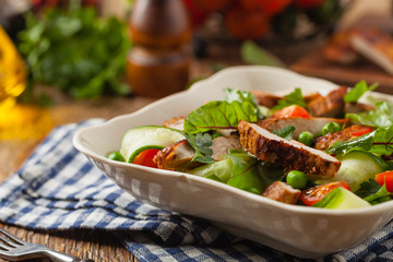Delicious salad with grilled veal, beetroot and cucumber. Front view.