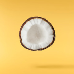 Fresh ripe coconut isolated on yellow background