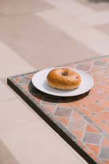 Breakfast Morning Sunny warm weather with donut on white plate on table background. Good mood Horizontal view