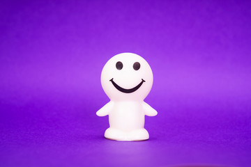 smiley face trinket on purple background