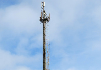 Tower with radar equipment, GSM communications antennas and transmitters against the beautiful blue...