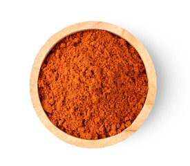 Crushed red chili pepper in wood bowl isolated on white background. top view