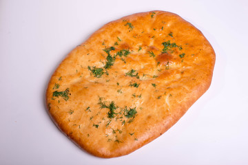 Flapjack with garlic and herbs. Baking on a white background