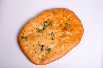 Flapjack with garlic and herbs. Baking on a white background