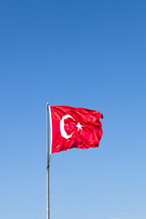 Turkish flag waving in the wind at blue sky