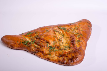 Closed pizza. Baking with sausage and cheese. Fast food on white background