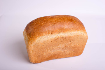 Baked loaf of bread on a white background. White square bread