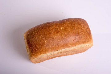 Baked loaf of bread on a white background. White square bread
