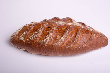 Wholegrain brown bread on a white background. Proper breakfast food