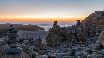 Beautiful coastal dreams with stone figures at sunrise