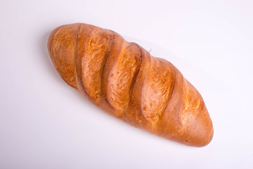Baked long loaf on white background