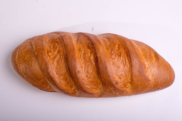 Baked long loaf on white background