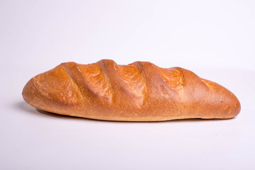 Baked long loaf on white background