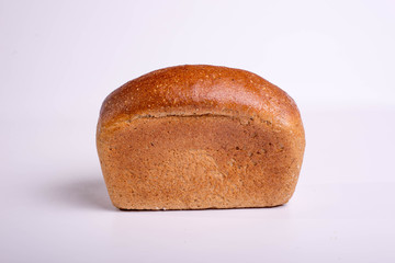 Gray bread on a white background. Insulated Baking Loaf