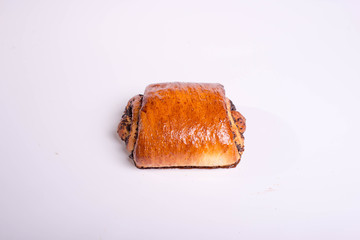 Small roll with poppy seeds. Snack for lunch. Dessert pastries on a white background