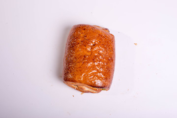 Small roll with poppy seeds. Snack for lunch. Dessert pastries on a white background