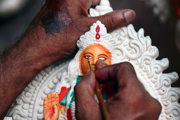 Idol of Hindu Goddess Lakshmi during preparations in Kolkata. Clay idol of Goddess Lakshmi, under preparation for Bengal`s Lakshmi Puja festival at Kumartuli Kolkata. 