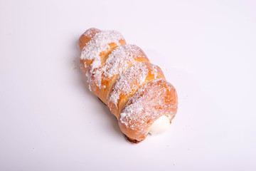 dessert in the form of tubes with cream. Buns covered with coconut flakes