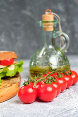 Sandwich with cheese, cucumber and Cherry Tomato on a wooden board. The sandwich is decorated with a lettuce leaf and cherry tomatoes.
