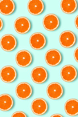 Colorful fruit pattern of fresh grapefruit slices on colored background. grapefruit slices top view.