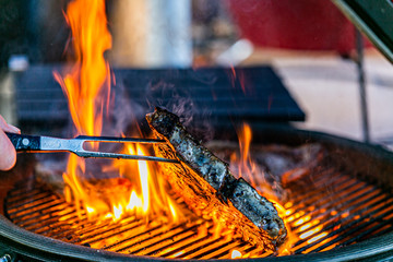 Grilling steaks on flaming grill.Beef steaks on grill.Grilling steak on BBQ