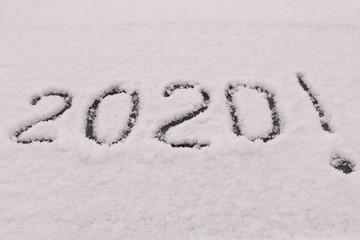 The inscription 2020 on the snow. The inscription on the glass of the car. The concept of a New year.