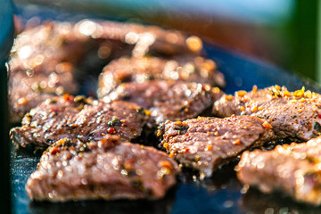 Closeup of a fresh roasted meat on flaming grill.