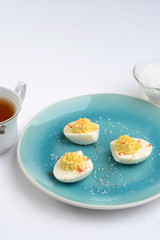 deviled eggs on a blue plate