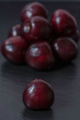 Dark cherries on black background