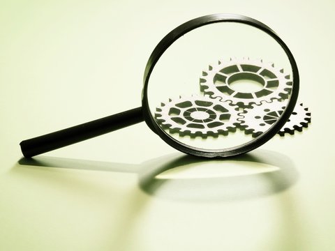 Magnifying Glass With Gears In The Background