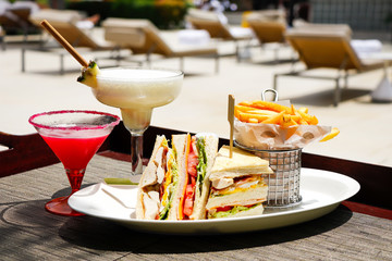 Enjoying Sandwich and drinks by the pool