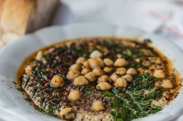 Traditional appetizer called hummus on a white plate in the southern of Turkey country