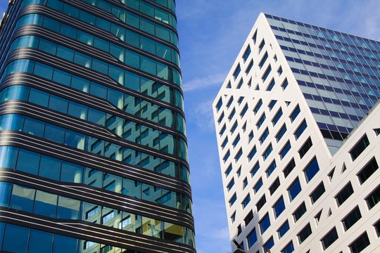 UTRECHT, NETHERLANDS - OCTOBER 20. 2018: Low angle view on skyscrapers with reflecting glass facade in city center