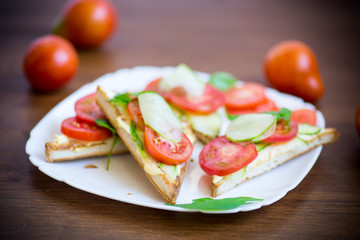tasty sandwich with curd paste, fresh cucumbers and tomatoes