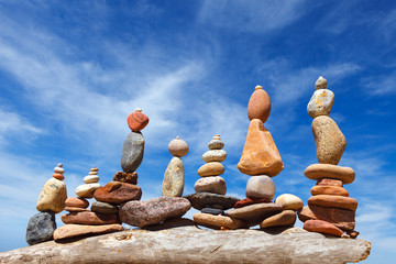 Several Rock zen pyramids of colorful pebbles on a beach on the background of the sea. Concept of...