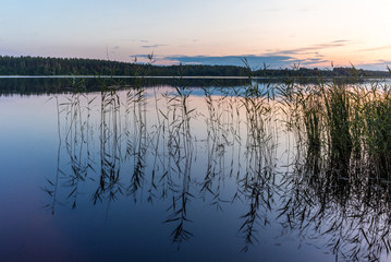 Reflections on the calm waters of the Saimaa lake in Finland at Sunset  - 7