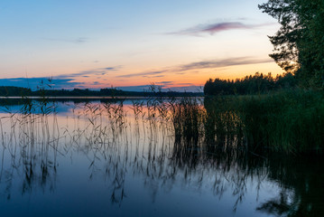 Reflections on the calm waters of the Saimaa lake in Finland at Sunset  - 8