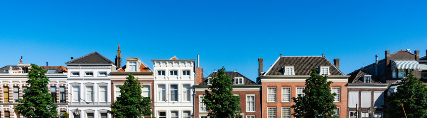 Obraz premium Panorama view. Facade of historical houses in street Wolwevershaven. Dordrecht, The Netherlands