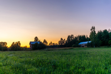 Fototapeta premium Traditional red nordic wooden shed in Finland during a colorful sunset - 2