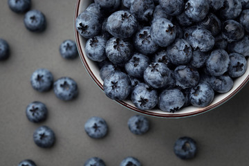 Fresh selected blueberries in bowl on dark gray table background