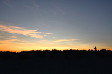 Fototapeta na wymiar Backlight shot. Enjoy a Belgian summer sunset in the dunes of Nieuwpoort. Belgium.