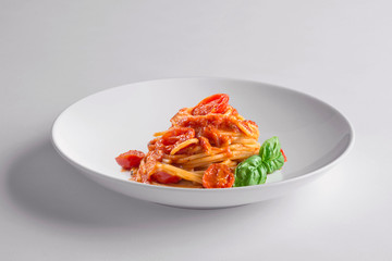 Elegant White round bowl with spaghetti tomato and basil
